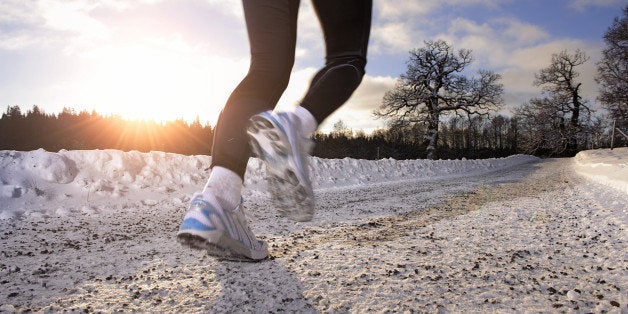 Mature woman jogging at sunset