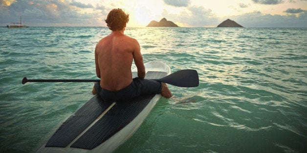 Caucasian man on paddle board in ocean