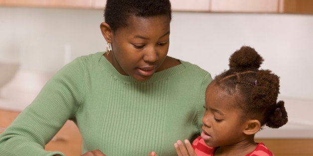 African mother helping daughter with homework