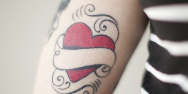 Heart shaped tattoo on woman's arm