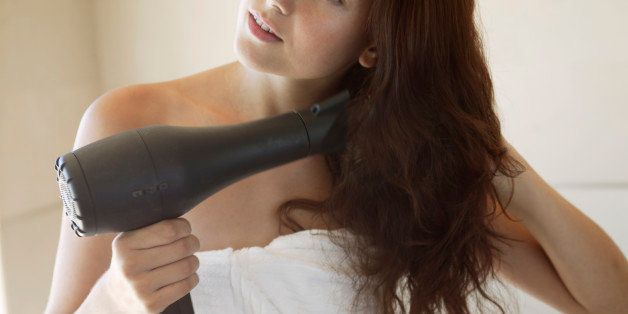 Woman Blow Drying Hair