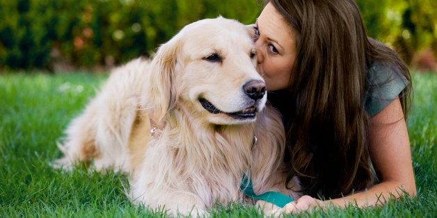 Woman kissing dog