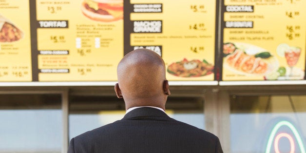 African American businessman looking at cafe menu