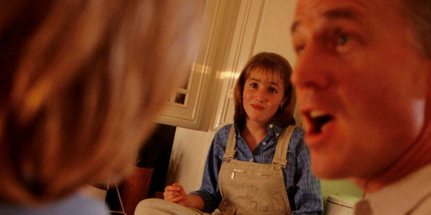 Father in kitchen having argument with mother about daughter (8-9)