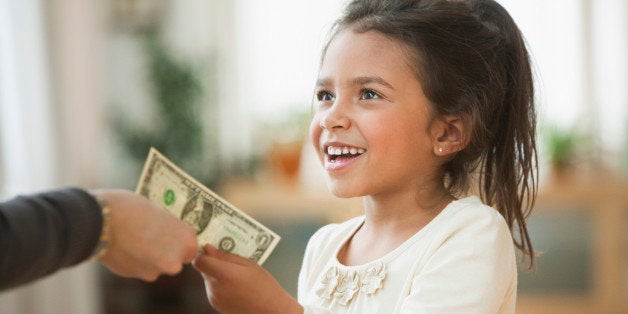 Mother handing girl one dollar bill