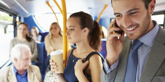 Passengers Standing On Busy Commuter Bus To Work