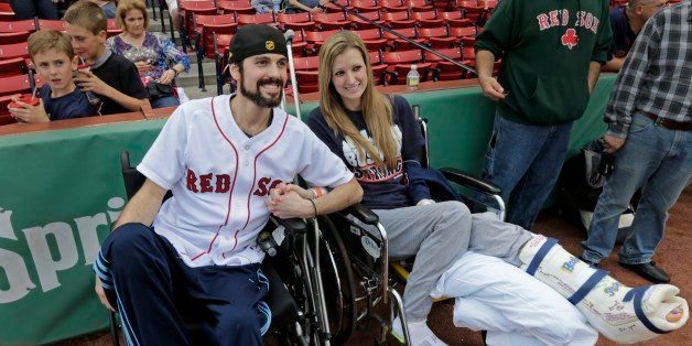 In this Thursday, May 23, 2013 photo, Boston Marathon bombing survivor Pete DiMartino, of Rochester, N.Y., and his girlfriend, Rebekah Gregory, hold hands prior to DiMartino throwing out the ceremonial first pitch before a Red Sox game at Fenway Park in Boston. DiMartino and Gregory were injured in an explosion near the finish line of the Boston Marathon. ￃﾢￂﾀￂﾜI donￃﾢￂﾀￂﾙt want anybody feeling sorry for me,ￃﾢￂﾀￂﾝ he said. ￃﾢￂﾀￂﾜ... I want people to see that this has made me a better person and I want people to become better people through what they see through me.ￃﾢￂﾀￂﾝ (AP Photo/Charles Krupa)