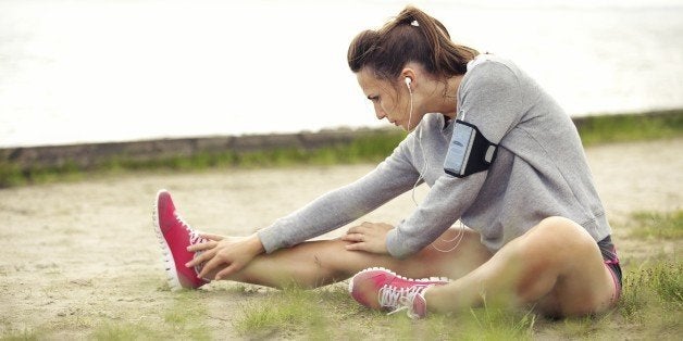 Woman outdoors stretching her legs