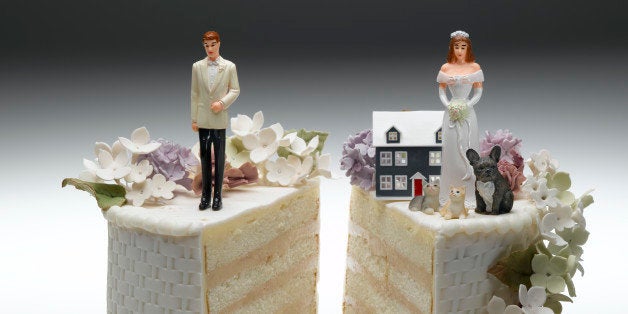 Bride and groom figurines standing on two separated slices of wedding cake