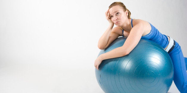 Frustrated woman on exercise ball