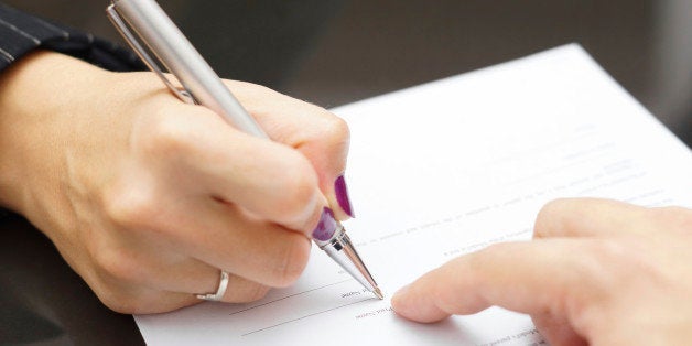 Man is showing woman where to sign