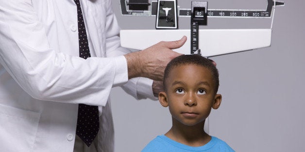 Doctor measuring child's height. 