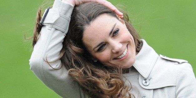 Kate Middleton holds her hair down from the wind, during a visit to Antrim, Northern Ireland, Tuesday March 8, 2011 with Britain's Prince William. The visit to Northern Ireland is the couple's third public outing in recent weeks, completing a circuit which has taken in all four corners of the United Kingdom of Great Britain and Northern Ireland since they announced their engagement. Last month, the couple traveled to Wales and to Scotland.(AP Photo/Michael Cooper)