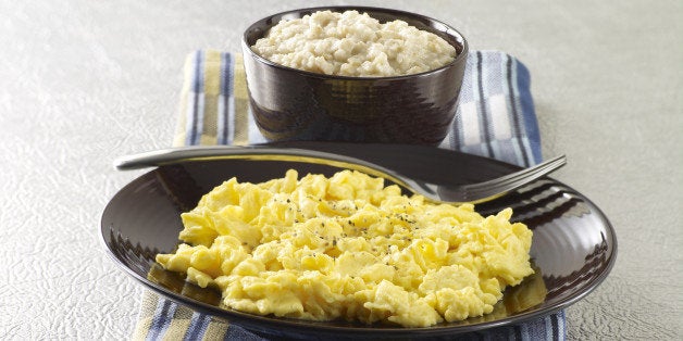 A plate of scrambled eggs and bowl of oatmeal