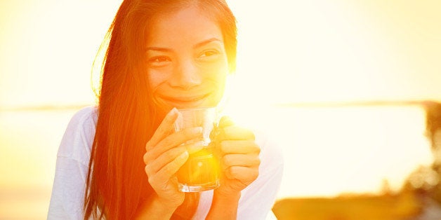 asian woman drinking coffee in...