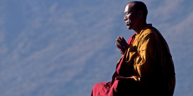 Tibetan Buddhist monk praying for world peace, Godegeng, Nepal