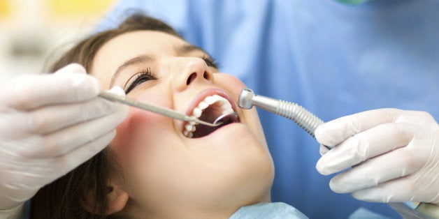 Dentist doing dental treatment to a woman