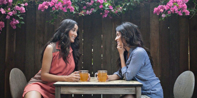 Two women having tea in back yard