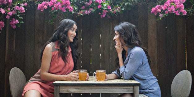 Two women having tea in back yard