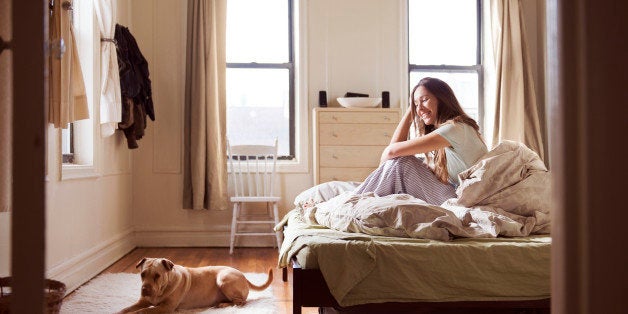 Woman On Bed With Dog At The Foot