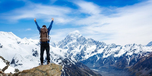 hiker at the top of a rock with ...