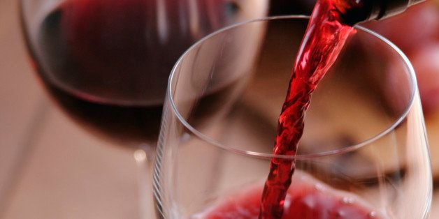 Red wine pouring into wineglass