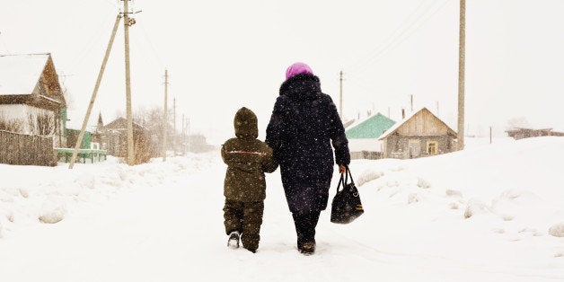 Mother and son walking in snow