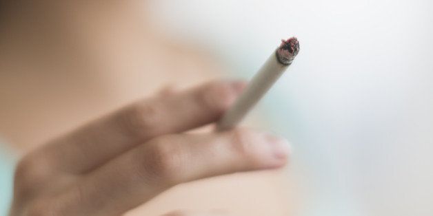 USA, New Jersey, Jersey City, Woman smoking cigarette