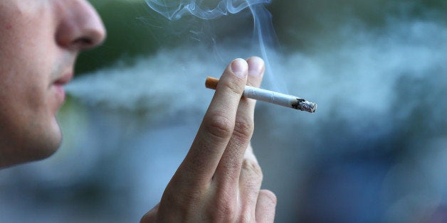 SYDNEY, AUSTRALIA - AUGUST 01: In this photo illustration a man smokes on August 1, 2013 in Sydney, Australia. In a plan announced today, the government will increase the excise on tobacco by 12.5 per cent annually over the next four years, raising over AUD$5 billion. The hike is estimated to increase the cost of cigarettes by AUD$5 by 2016, and is the first increase in the tobacco excise since 2010. (Photo by Cameron Spencer/Getty Images)