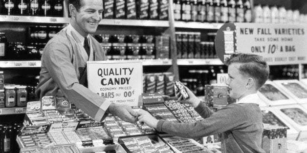 YOUNG BOY BUYING CANDY AT GROCERY STORE