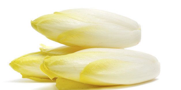 closeup of some Belgian endives on a white background.