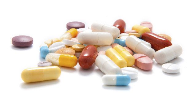 A choice of capsules and tablets on white background.