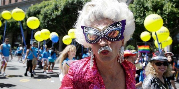 A man dressed in drag marches with a group of employees and family members with Kaiser Permanente during the 44th annual San Francisco Gay Pride parade Sunday, June 29, 2014, in San Francisco. The lesbian, gay, bisexual, and transgender celebration and parade is one of the largest LGBT gatherings in the nation. (AP Photo/Eric Risberg)