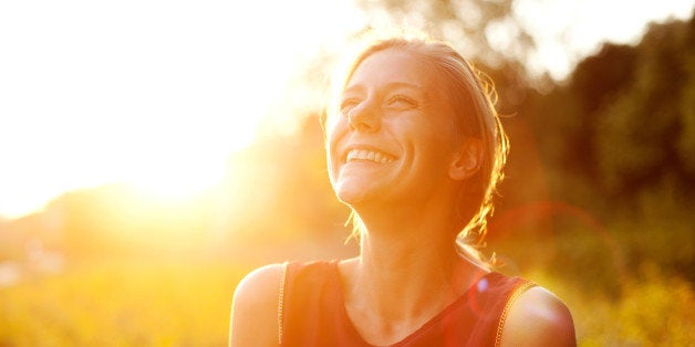 Young woman using smart phone at sunset