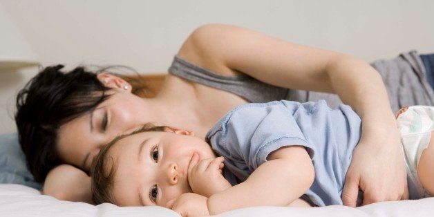 Mother and son lying down on bed