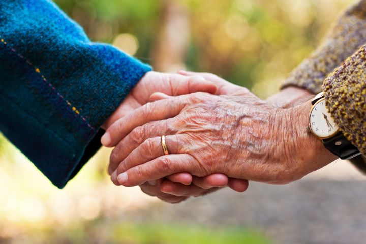 elderly couple holding hands...