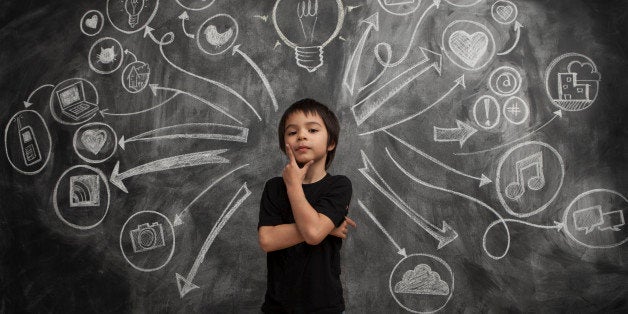 Kid boy stands with social media icon chalkboard