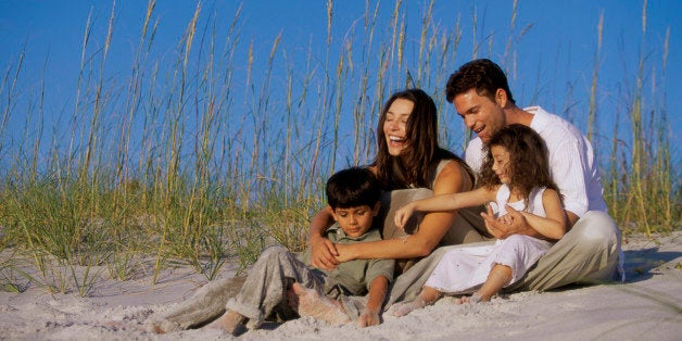 Parents with their son and daughter on the beach