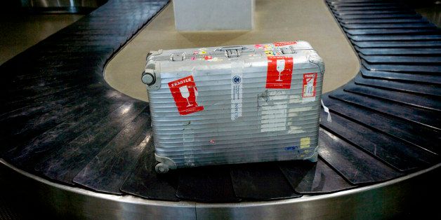 Suitcase on belt conveyer of luggage substitution