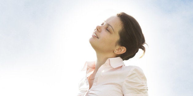 Portrait Of Young Woman Relaxing In Grassland