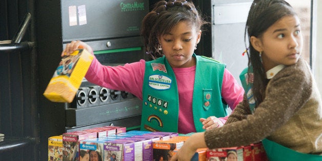 UPPER MARLBORO, MD - FEBRUARY 26: Girl scouts sell cookies at Freeman's Barber Shop in Upper Marlboro, MD. Lalah Williams, left, 10, of Upper Marlboro, MD, is helping sell the cookies, but has also utilized the internet to become one of the top sellers in the area. Hilary Foinding, 9, of Upper Marlboro, MD is on the right. (Photo by Sarah L. Voisin/The Washington Post via Getty Images)