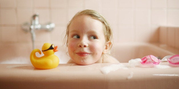 A 5 years old girl taking her bath