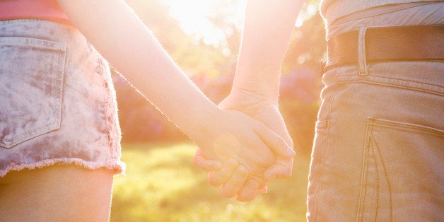 Couple walking in sunshine.