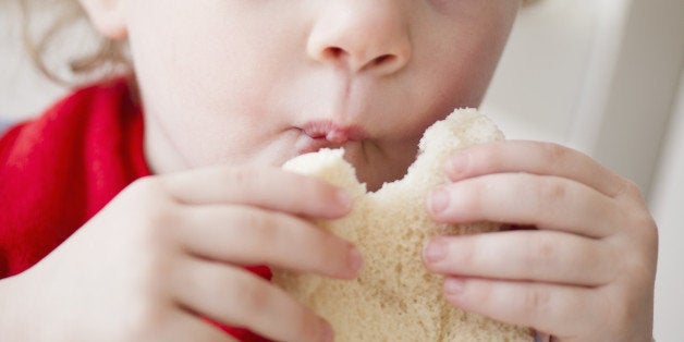 USA, New Jersey, Jersey City, Girl (2-3) eating sandwich