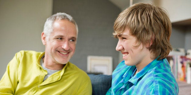 Man and his son smiling at home