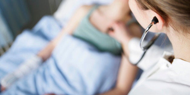 A doctor listening to a stethoscope