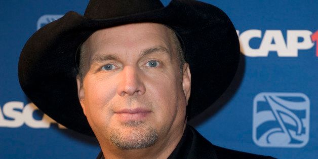 FILE - In this Nov. 17, 2014 file photo, Garth Brooks attends the 2014 ASCAP Centennial Awards, benefiting the ASCAP Foundation and its music education, talent development and humanitarian activities, at the Waldorf-Astoria in New York. Brooks has canceled a Thanksgiving appearance on NBC's "Tonight" show because he said it "seemed distasteful" given the reaction to the decision not to prosecute Ferguson police officer Darren Wilson for the shooting of Michael Brown this summer. NBC on Wednesday, Nov. 26, confirmed the postponement, saying Brooks was being replaced on the show by Whoopi Goldberg and Tom Colicchio. (Photo by Stephen Chernin/Invision/AP, File)