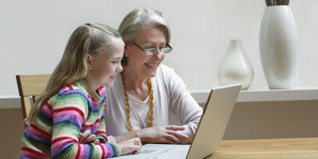Grandmother and Granddaughter using a Laptop PC