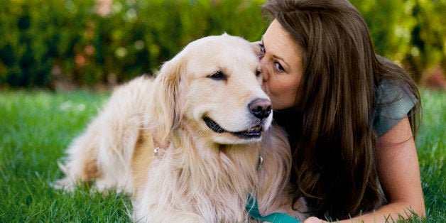 Woman kissing dog