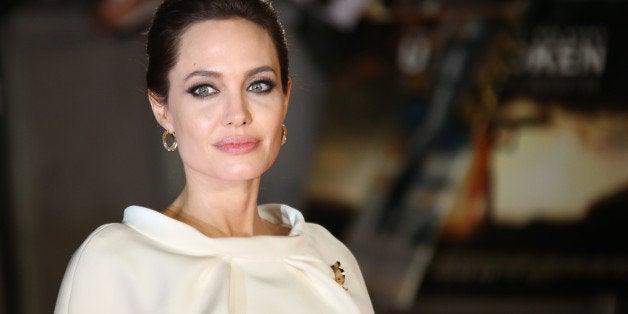 Actress Angelina Jolie poses for photographers upon arrival at the premiere of the film Unbroken in London, Tuesday, Nov. 25, 2014. (Photo by Joel Ryan/Invision/AP)